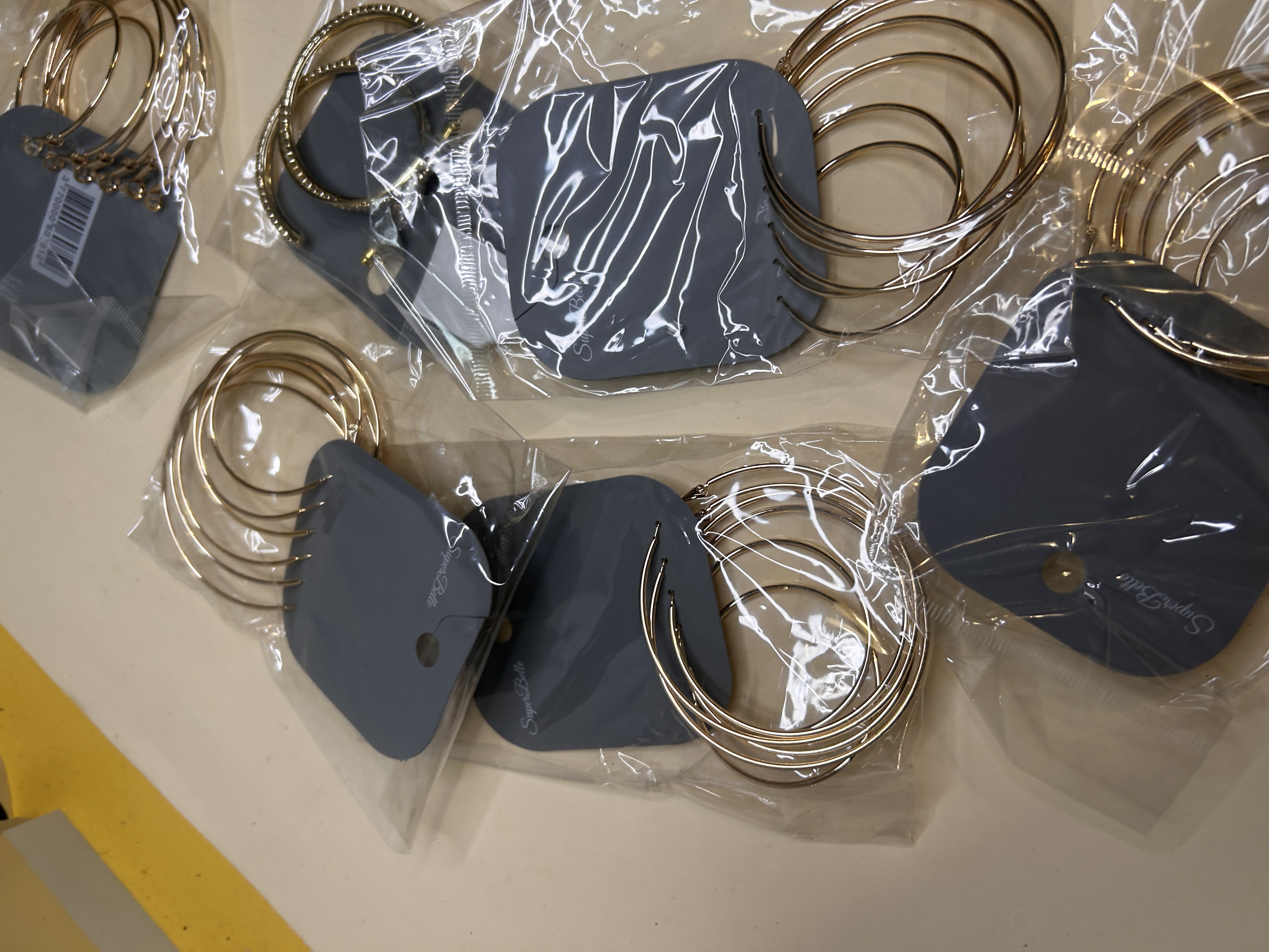 Vista general de varios paquetes de aros dorados listos para tienda — lote de pendientes de moda, vista lateral · Lotes Bisutería (HOOP-203)