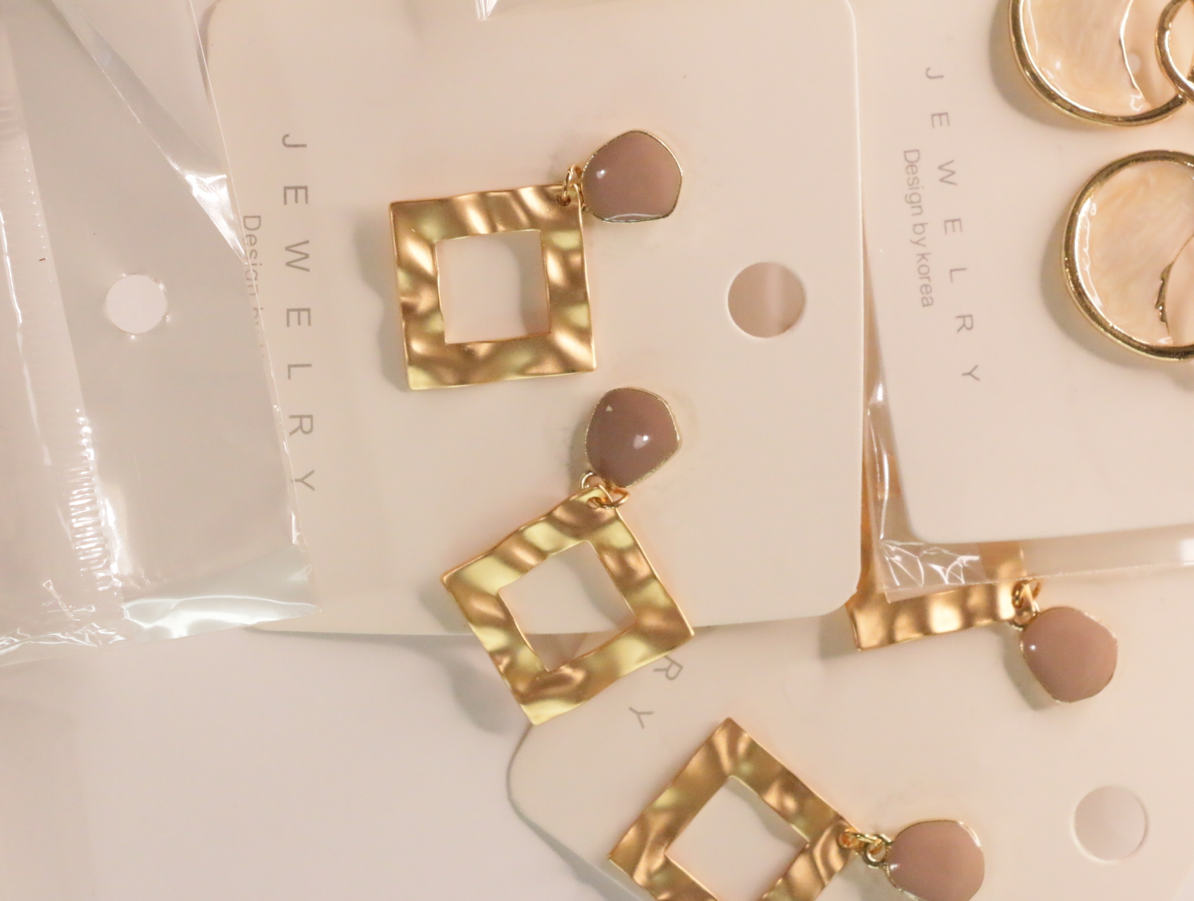 Pendientes colgantes geométricos dorados con detalles nude brillantes — lote de bisutería originales, detalle del acabado · Lotes Bisutería (LT049)