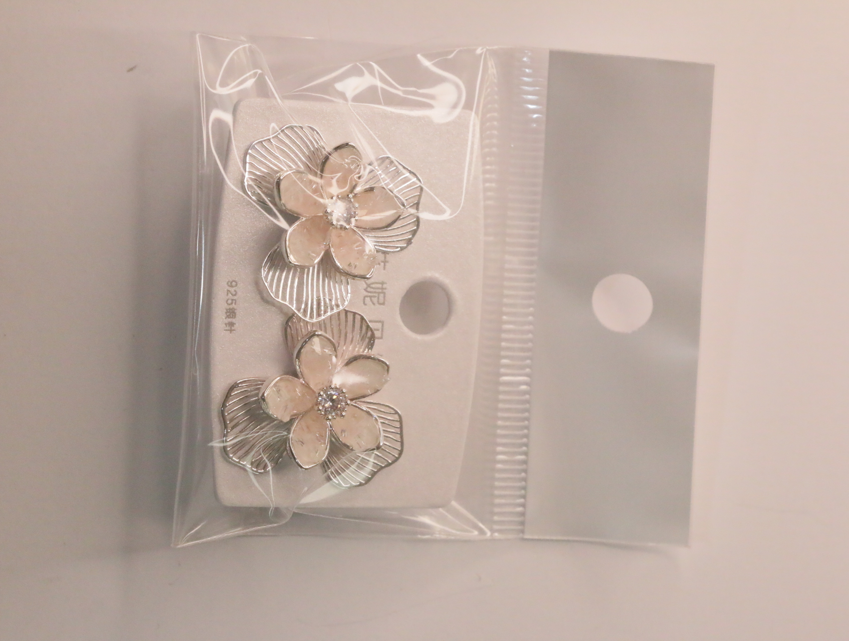 Vista frontal de pendientes florales sobre su tarjeta — lote de bisutería dorados, primer plano · Lotes Bisutería (LT066)